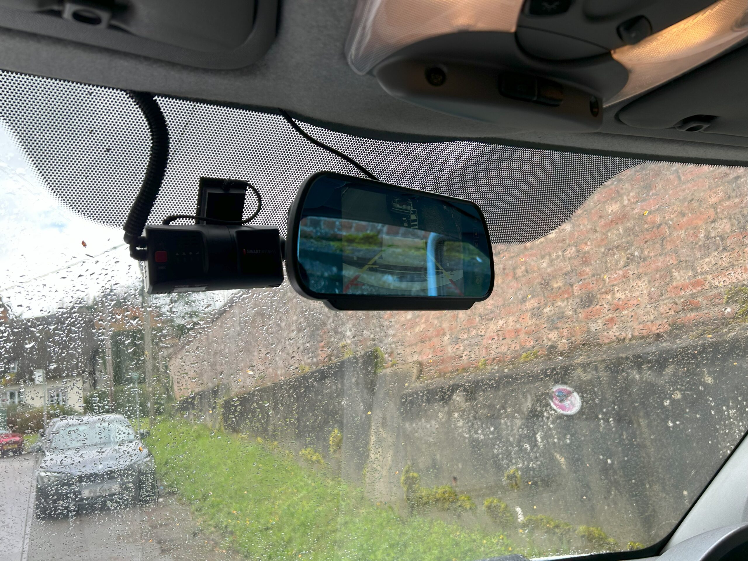 A dashcam and reversing mirror fitted into a vehicle by an auto electrician.